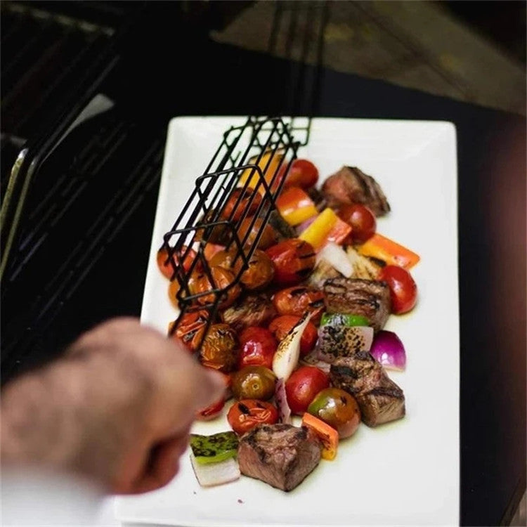Plated dish of grilled vegetables and meat skewers on a white plate with a person's hand reaching towards it.