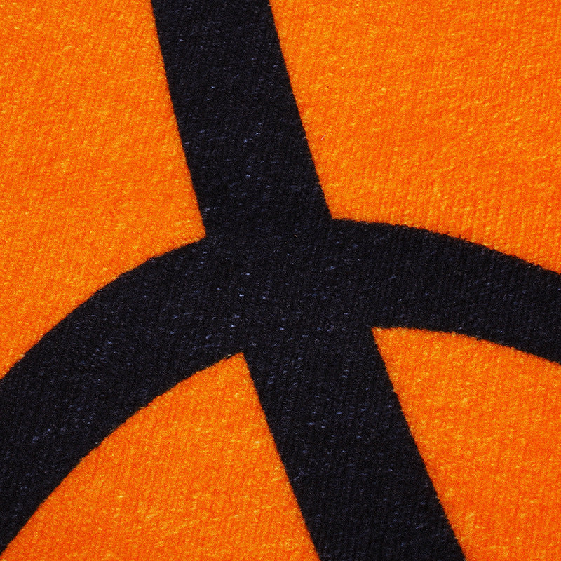 Close-up of an orange basketball with a black logo
