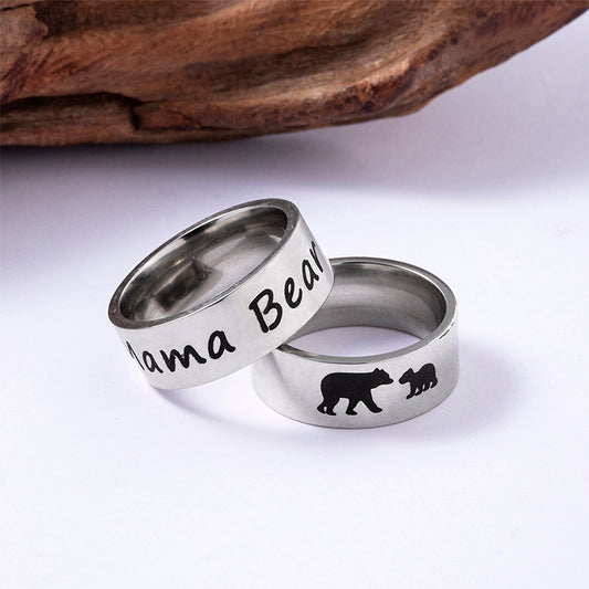 Two silver rings with 'Mama Bear' and bear illustrations on a white background.