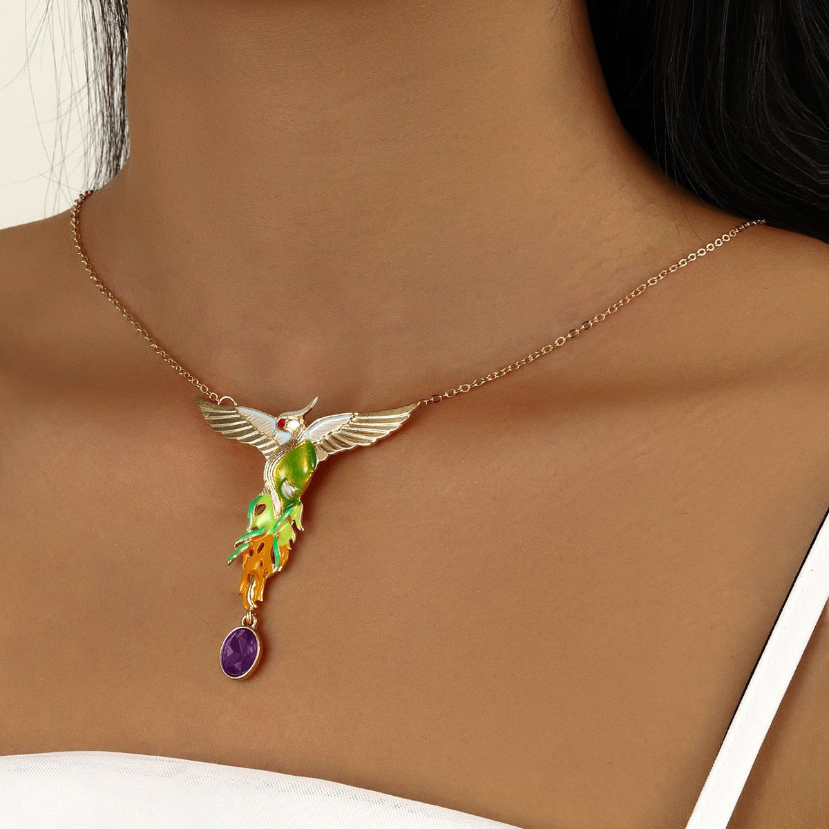 Colorful bird-shaped pendant necklace on a person's neck