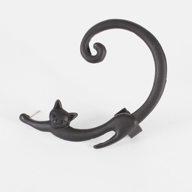 Black cat-shaped earring on a white background
