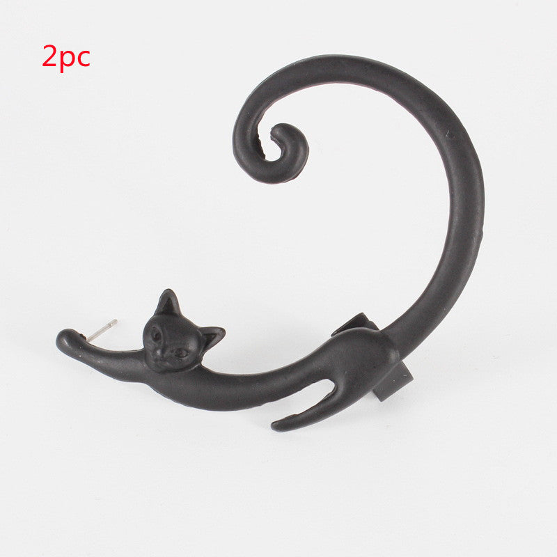Black cat-shaped earring on a white background
