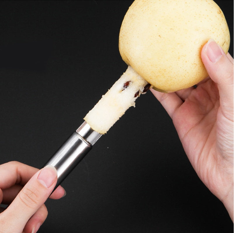 Person using a kitchen tool to remove the core of a mushroom against a black background