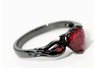 Ring with red gemstone on a white background