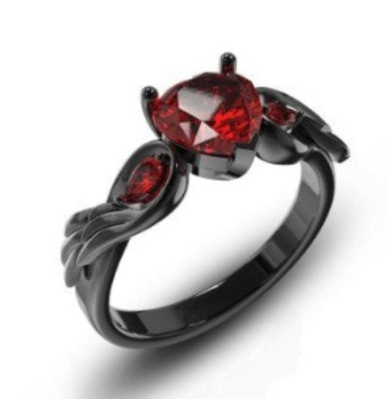 Black ring with red gemstones on a white background