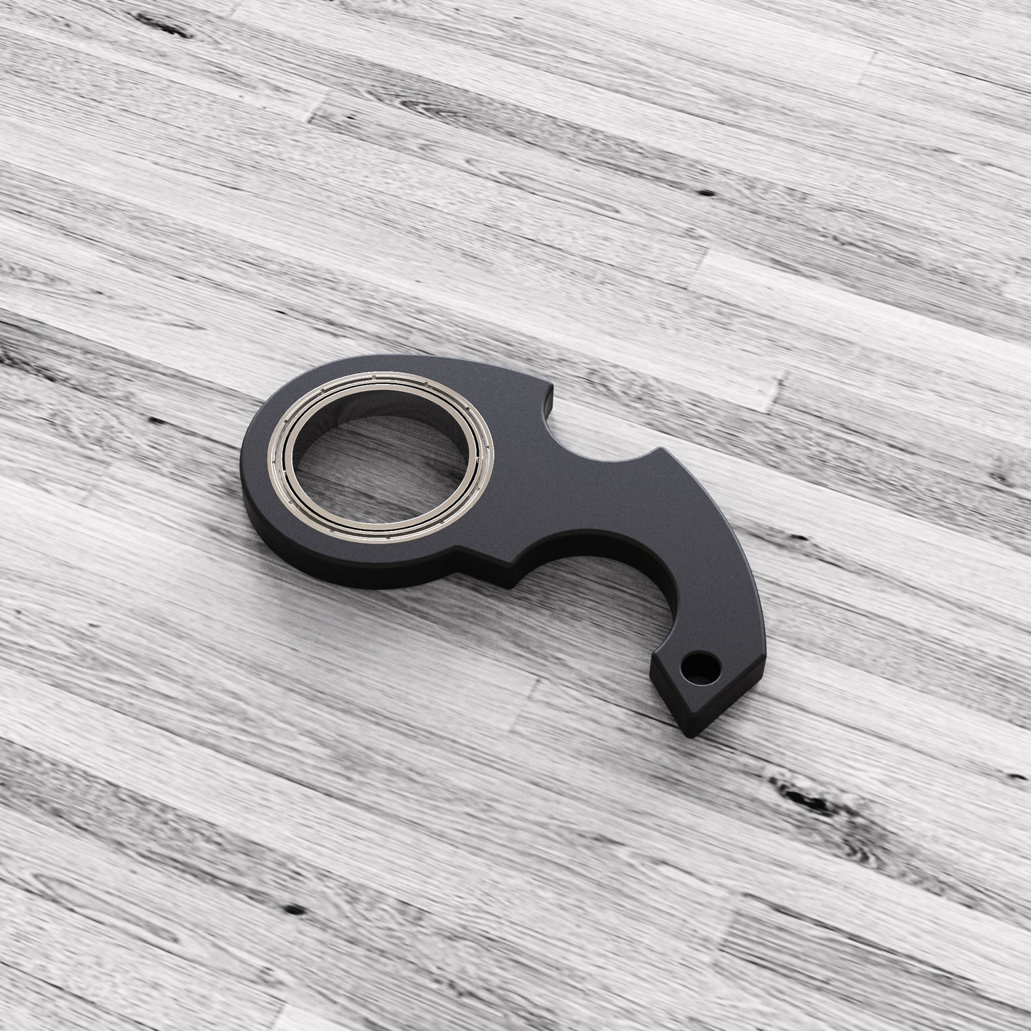 Black metal tool on a gray wooden surface