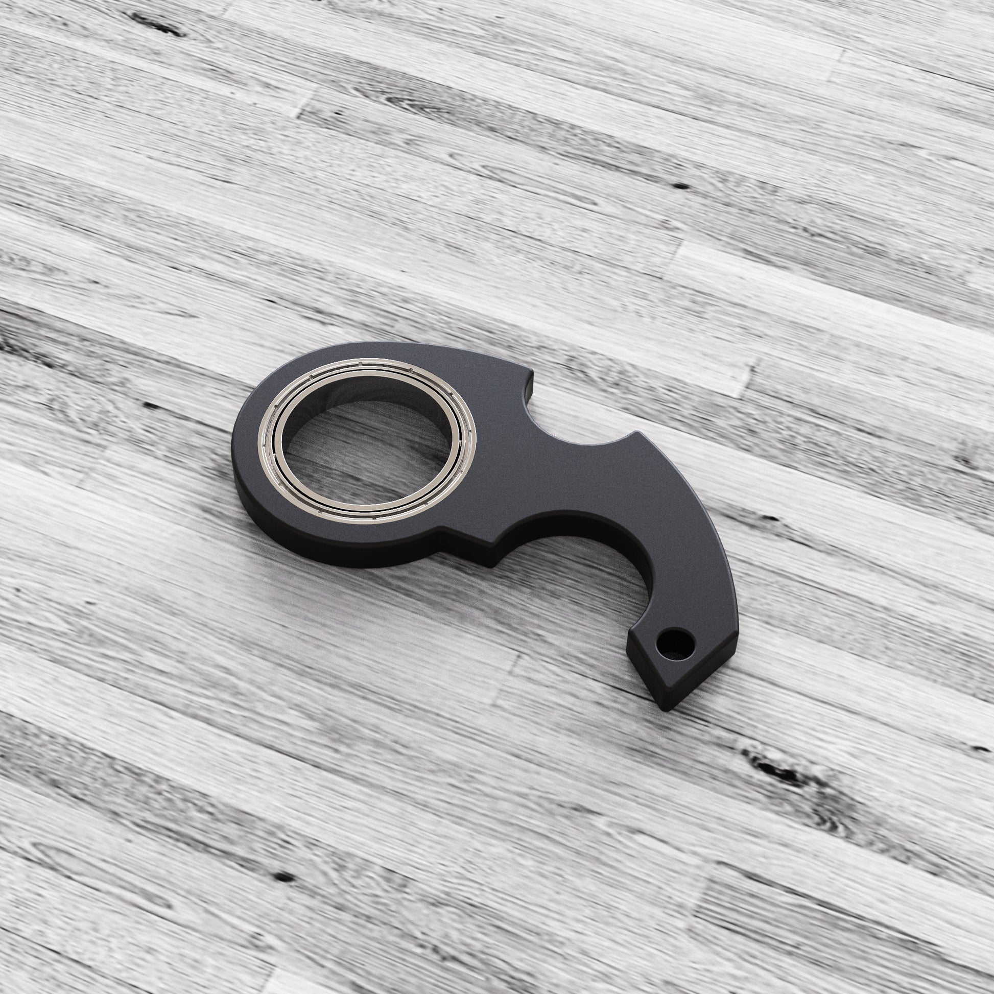 Black metal tool on a gray wooden surface