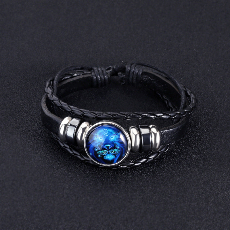 Black braided leather bracelet with a blue stone on a dark background