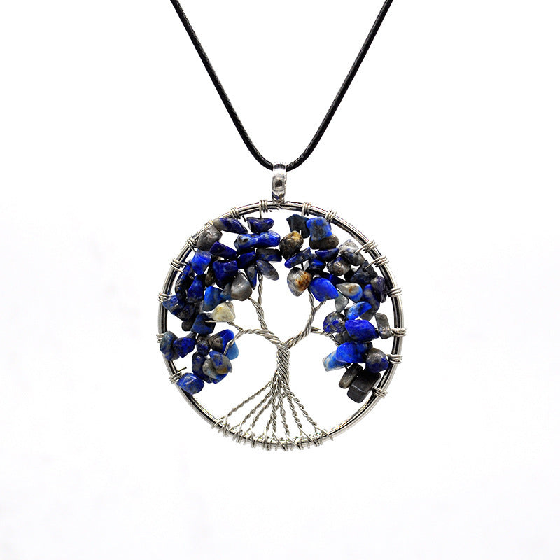 Tree-shaped pendant with blue stones on a white background