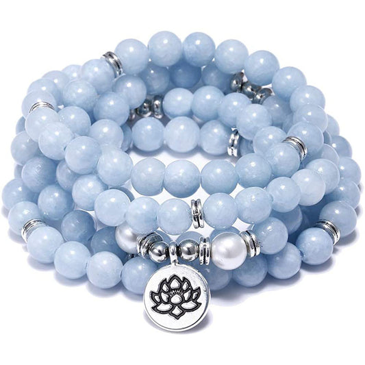 Stack of light blue beaded bracelets with a silver lotus charm on a white background