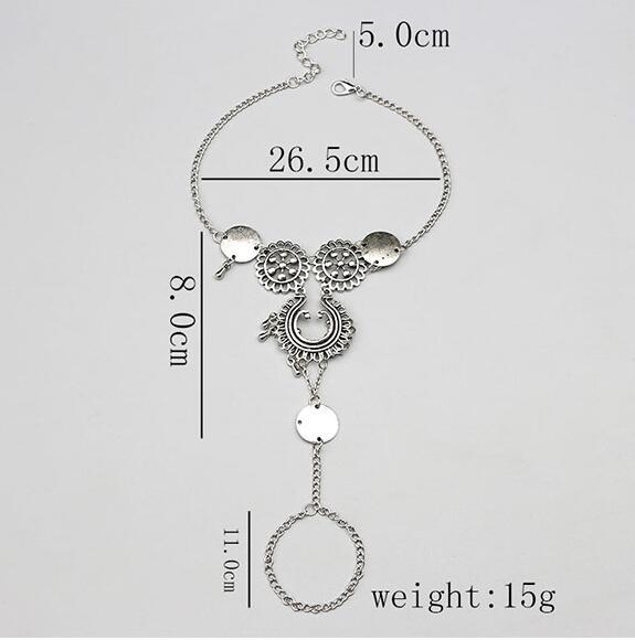 Silver anklet with measurements on a light gray background