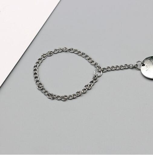 Silver chain bracelet on a light gray background