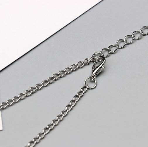 Silver chain necklace on a gray background