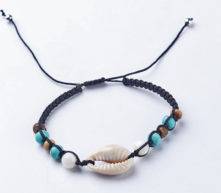 Bracelet with beads and a shell on a white background