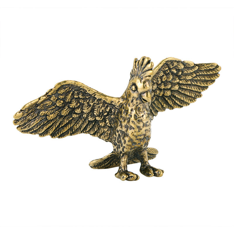 Brass eagle figurine with open wings on a white background