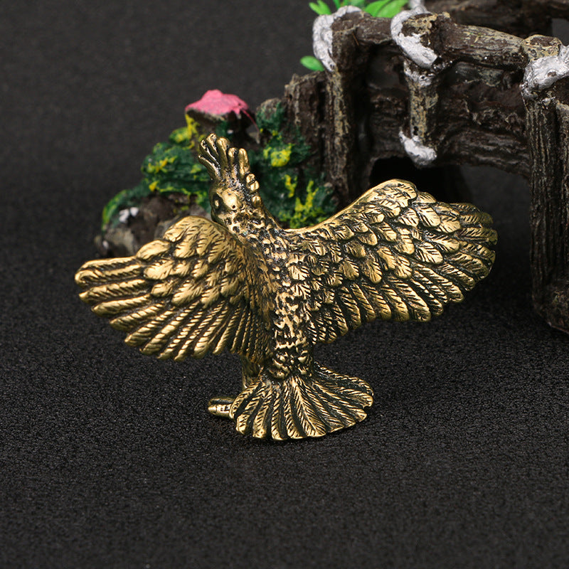 Brass eagle figurine on a dark background