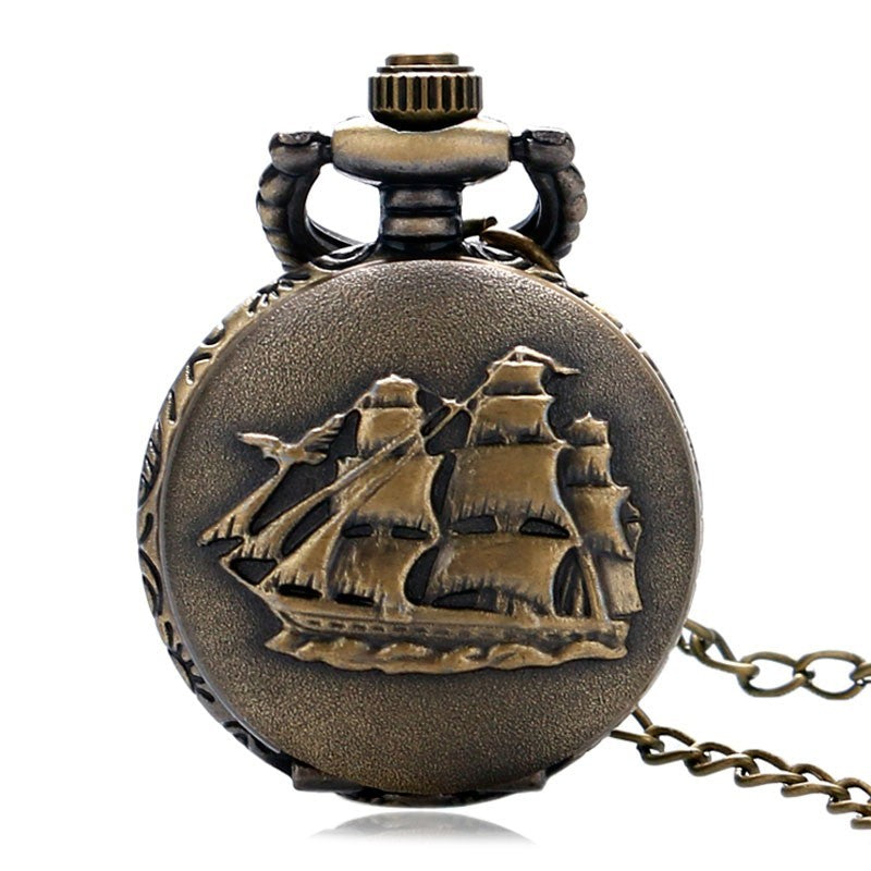 Bronze pocket watch with ship design on a white background