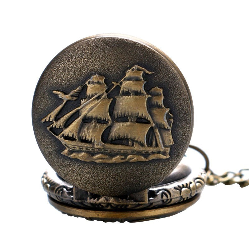 Bronze pocket watch with ship design on a white background