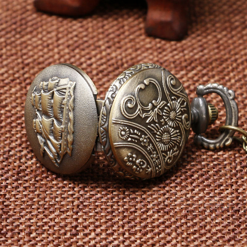 Decorative bronze keychain with intricate designs on a brown textured background