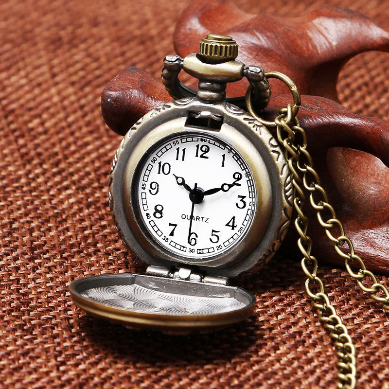 Vintage pocket watch with chain on a brown textured background