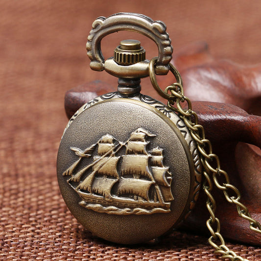 Bronze pocket watch with ship design on a brown textured background