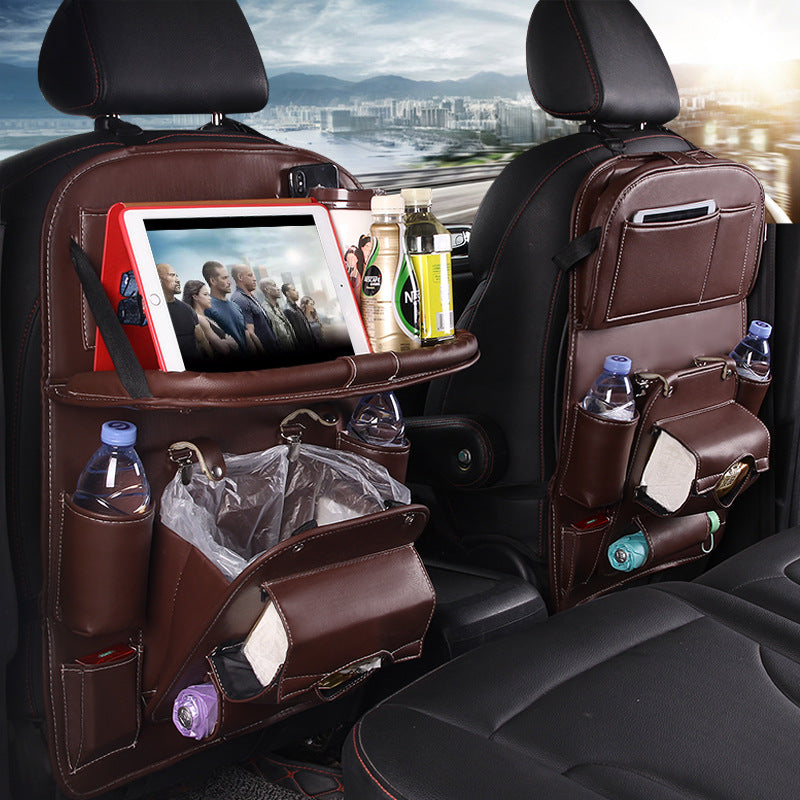 Car back seat organizer with multiple pockets and a tablet stand, cityscape in the background