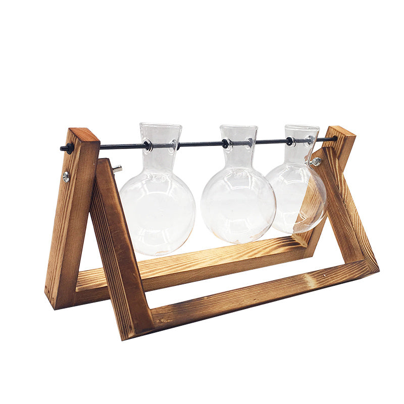 Wooden stand with three glass beakers on a white background