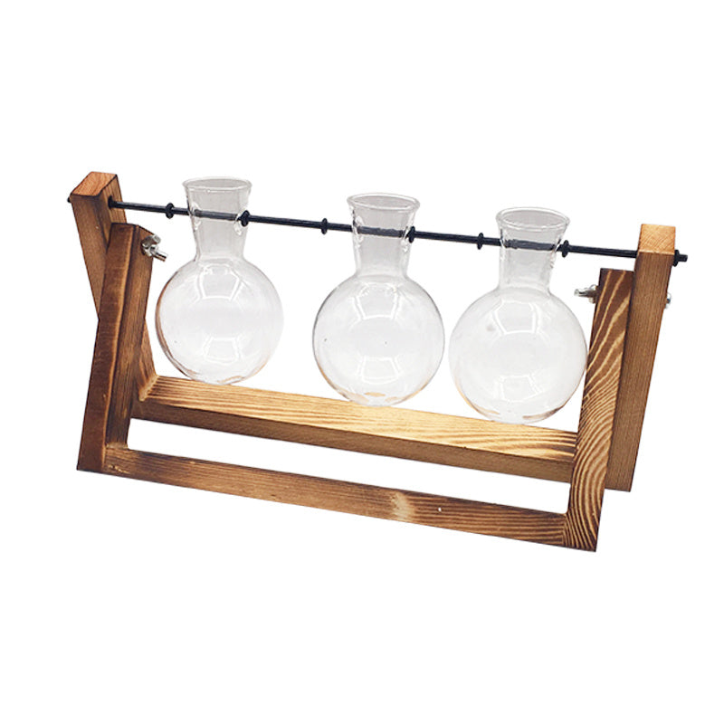 Three glass beakers on a wooden stand against a white background