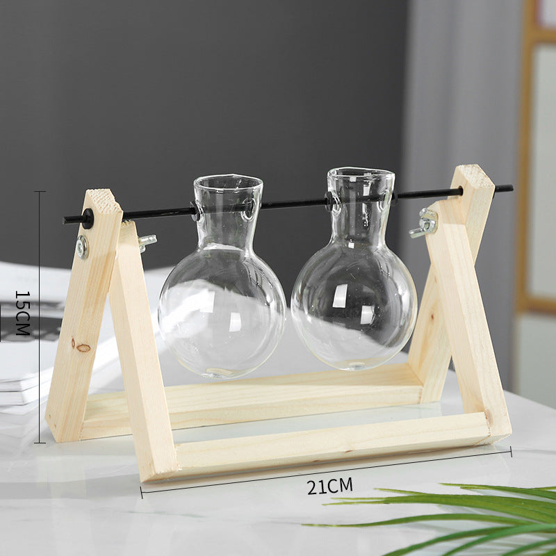 Two glass carafes on a wooden stand with measurements indicated.