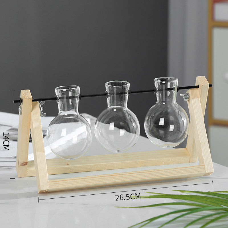 Three glass vases on a wooden stand with measurements displayed.