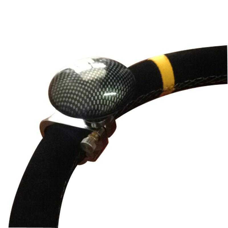 “Clamp-on steering wheel spinner knob mounted on rim for 360-degree one-hand control”