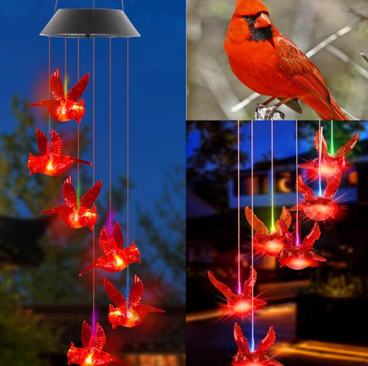 Solar-powered LED bird-shaped chime with red lights against a blue sky.