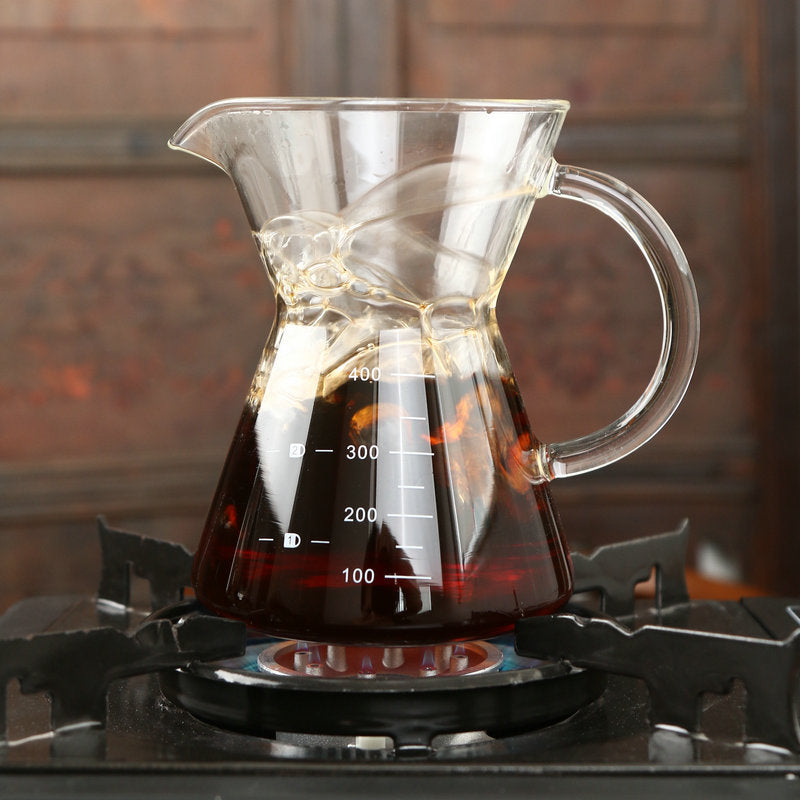 Clear glass coffee maker with liquid on a stove