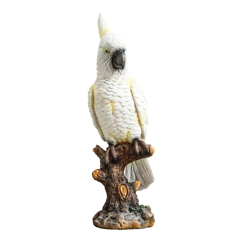 White parrot figurine on a branch with a white background