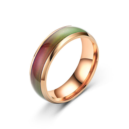 Ring with rose gold band and multicolored stone on a white background