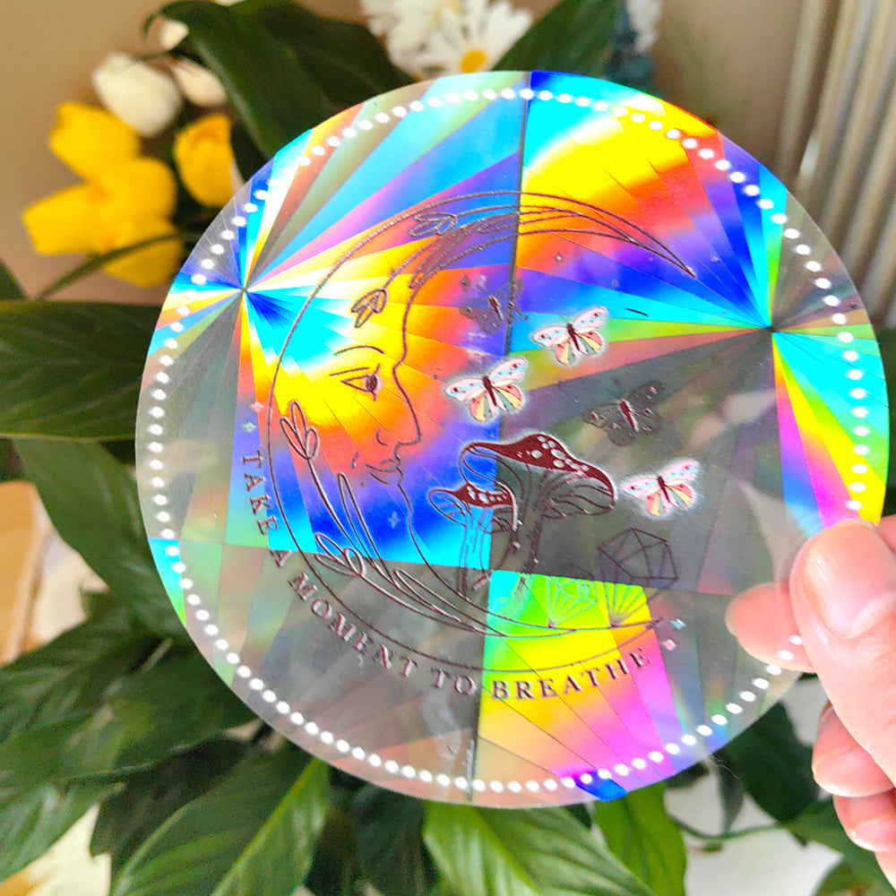 Holographic disc with butterfly design held by a hand, with plants and flowers in the background