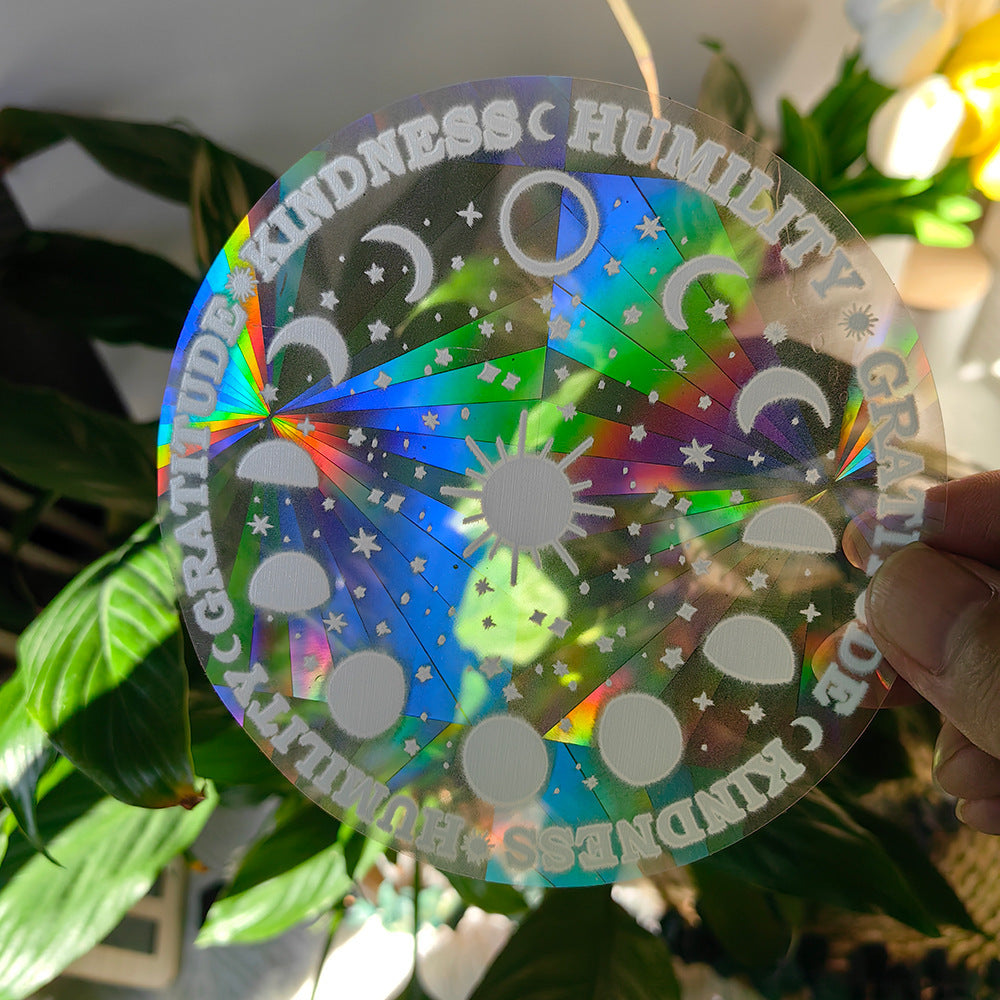 Holographic disc with motivational phrases held in front of green plants