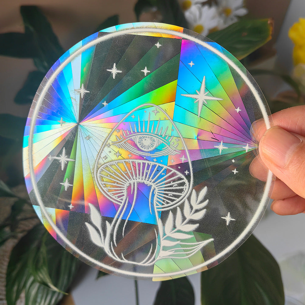 Holographic disc with star and mushroom design held by a hand against a blurred natural background