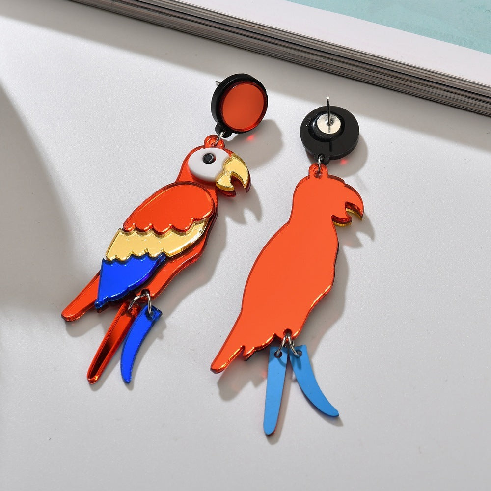 Colorful parrot-shaped earrings on a light gray background