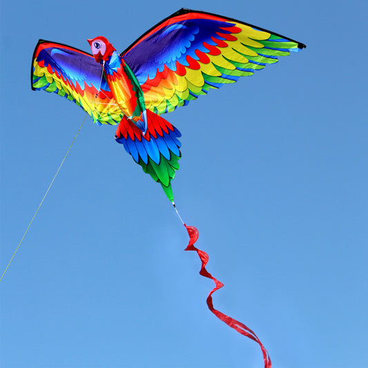 Colorful parrot-shaped kite against a clear blue sky