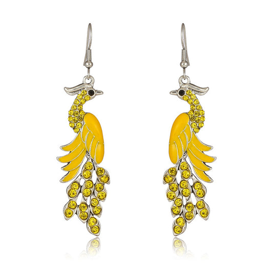 Pair of yellow feather-shaped earrings on a white background