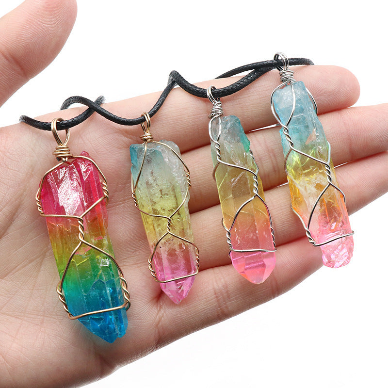 Colorful crystal pendants on a hand with a white background