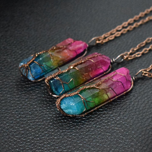Necklace with colorful stone pendants on a dark textured surface