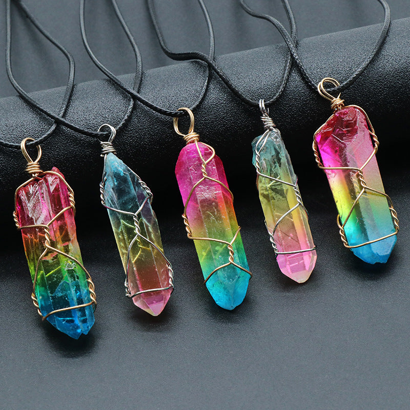 Colorful crystal pendants on black necklaces against a dark background