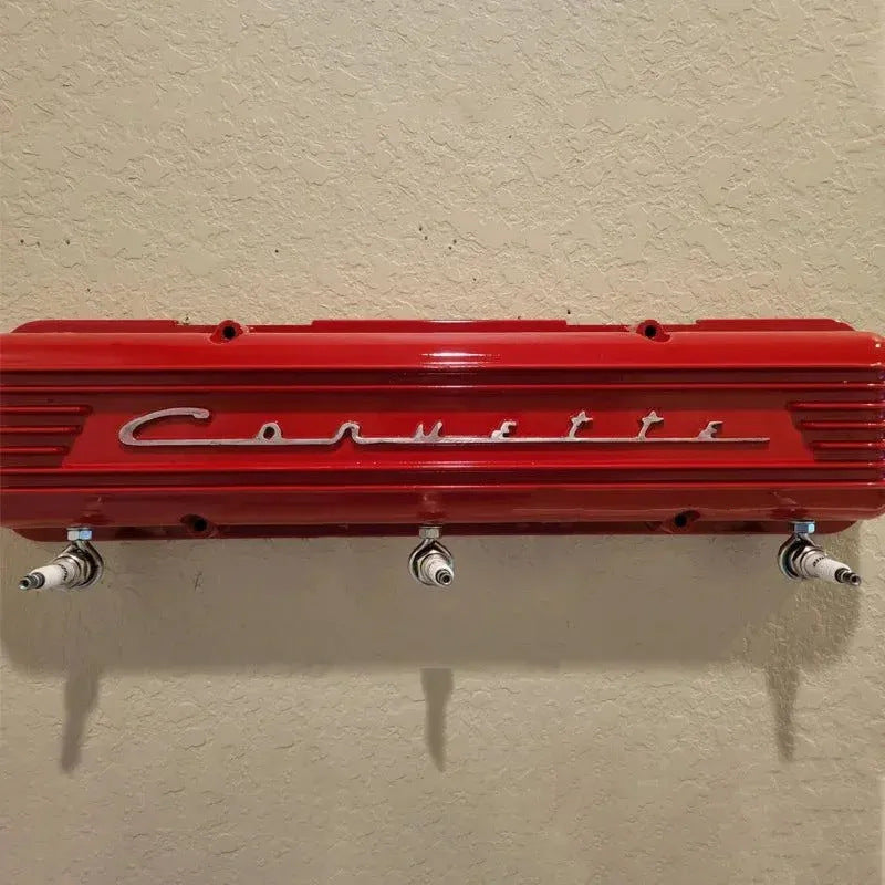 Red Chevrolet engine cover on a beige wall