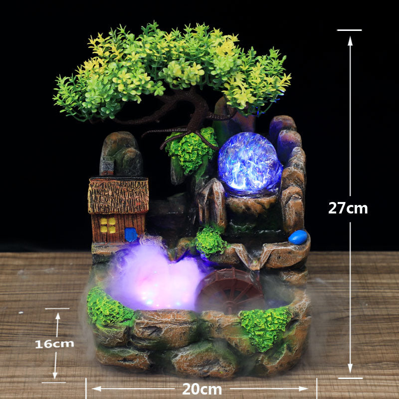 Decorative fountain with LED lights and measurements on a wooden surface
