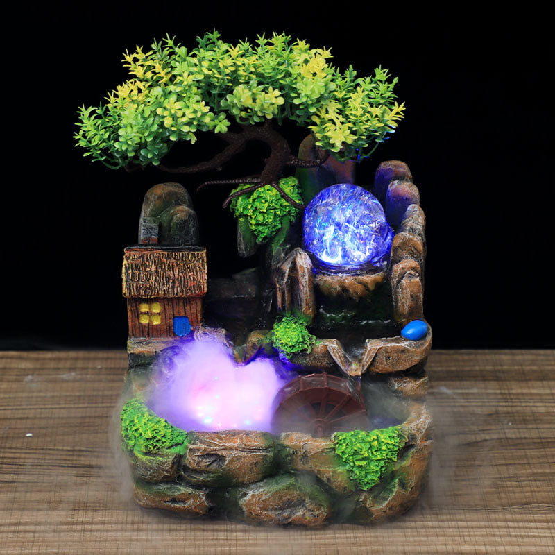 Decorative fountain with LED lights on a wooden surface