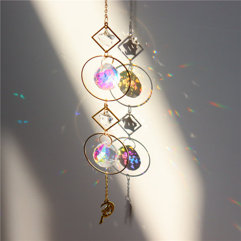 Decorative hanging crystal with rainbow effects on a plain background