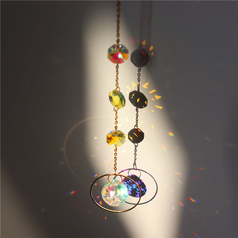 Decorative hanging crystal ball with colorful beads on a dark background