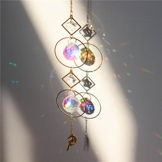 Decorative hanging crystal with rainbow effects on a plain background